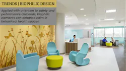 Patient reception and visiting area in a pediatric unit contains soft furnishings with rounded edges and a silhouetted meadow scene printed onto wall protection