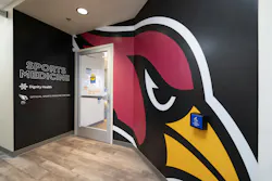 The Amplify wallcovering transforms walls into large-scale branding at the Arizona Cardinals' Dignity Health Sports Medicine Clinic in Yavapai County. It features the Cardinals mascot and clear Sports Medicine signage.