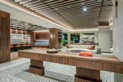 Spacious central lounge offers access to golf simulator, bowling lane, and other amenities