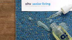 Alta Senior Living upholstery fabric with a bottle and pipette spilt on top.