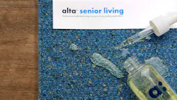 Alta Senior Living upholstery fabric with a bottle and pipette spilt on top.