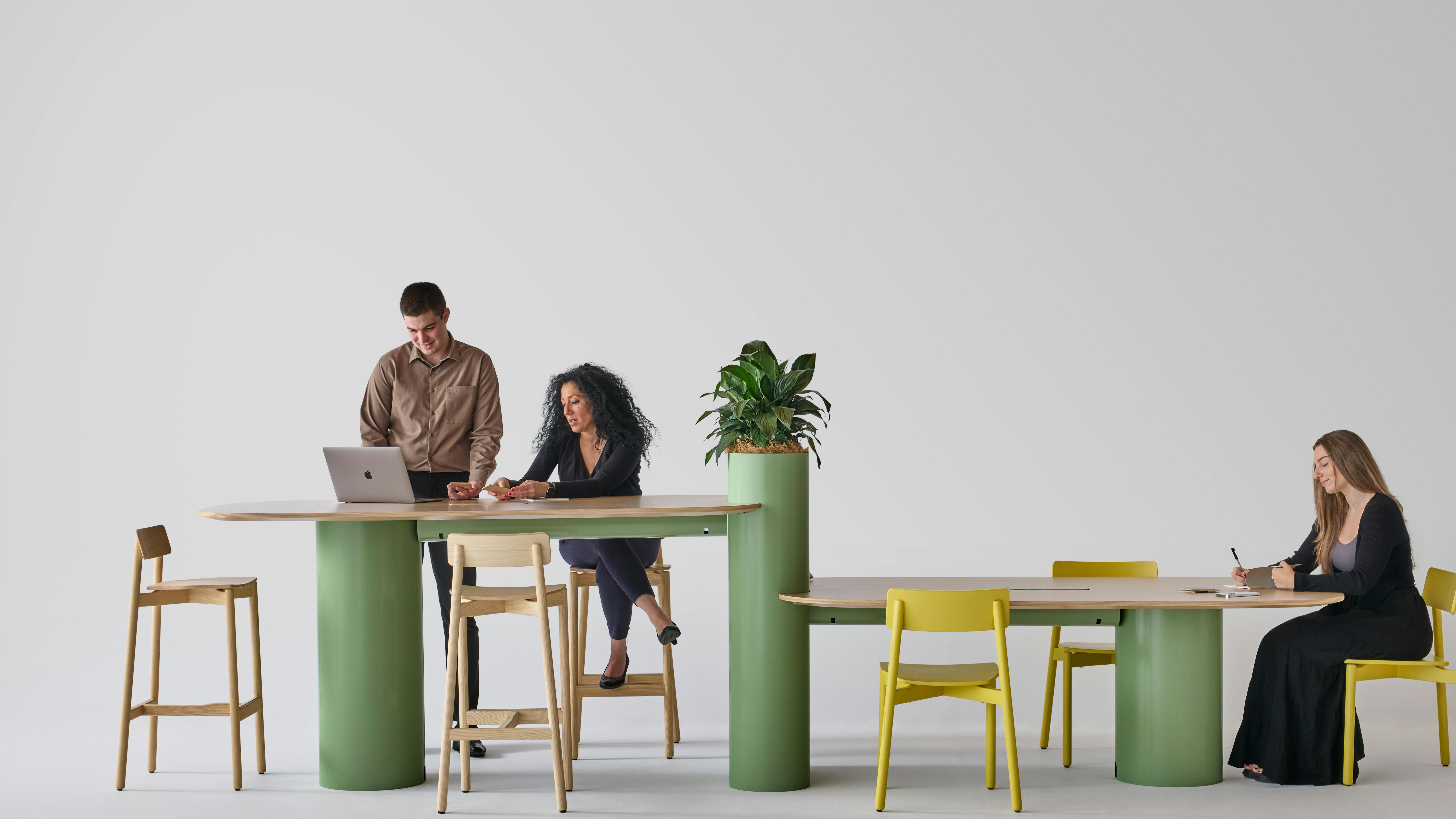 Totem Tables and Totem Planters support collaboration in various spaces.