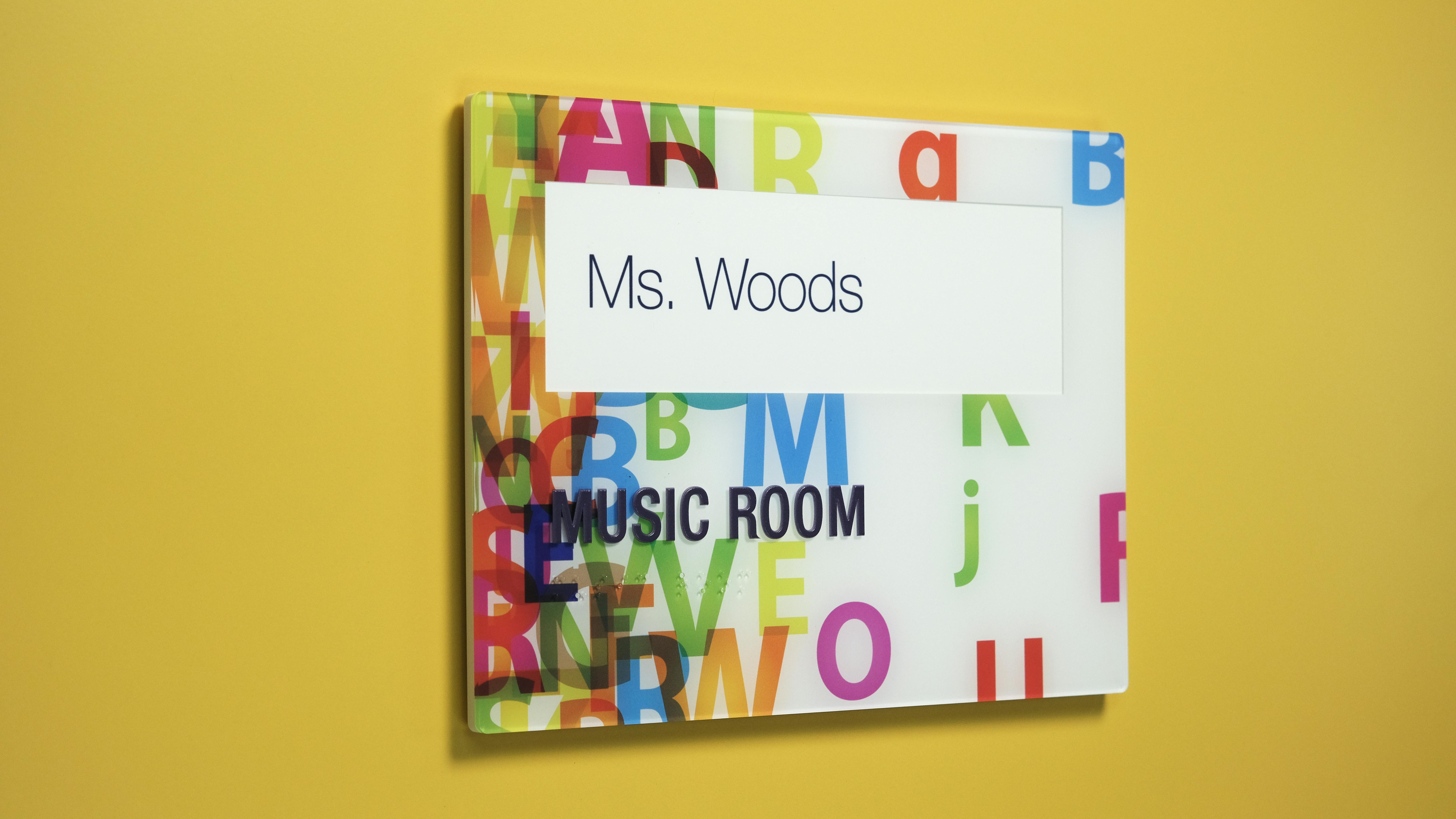 Takeform's Inspire signage with a music room label on it for an educational building.