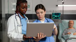 Black female doctor and white female nurse discussing care plan, with senior white male patient in the background