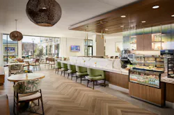Cafe with curved back, upholstered chairs, small round tables, and counter seating