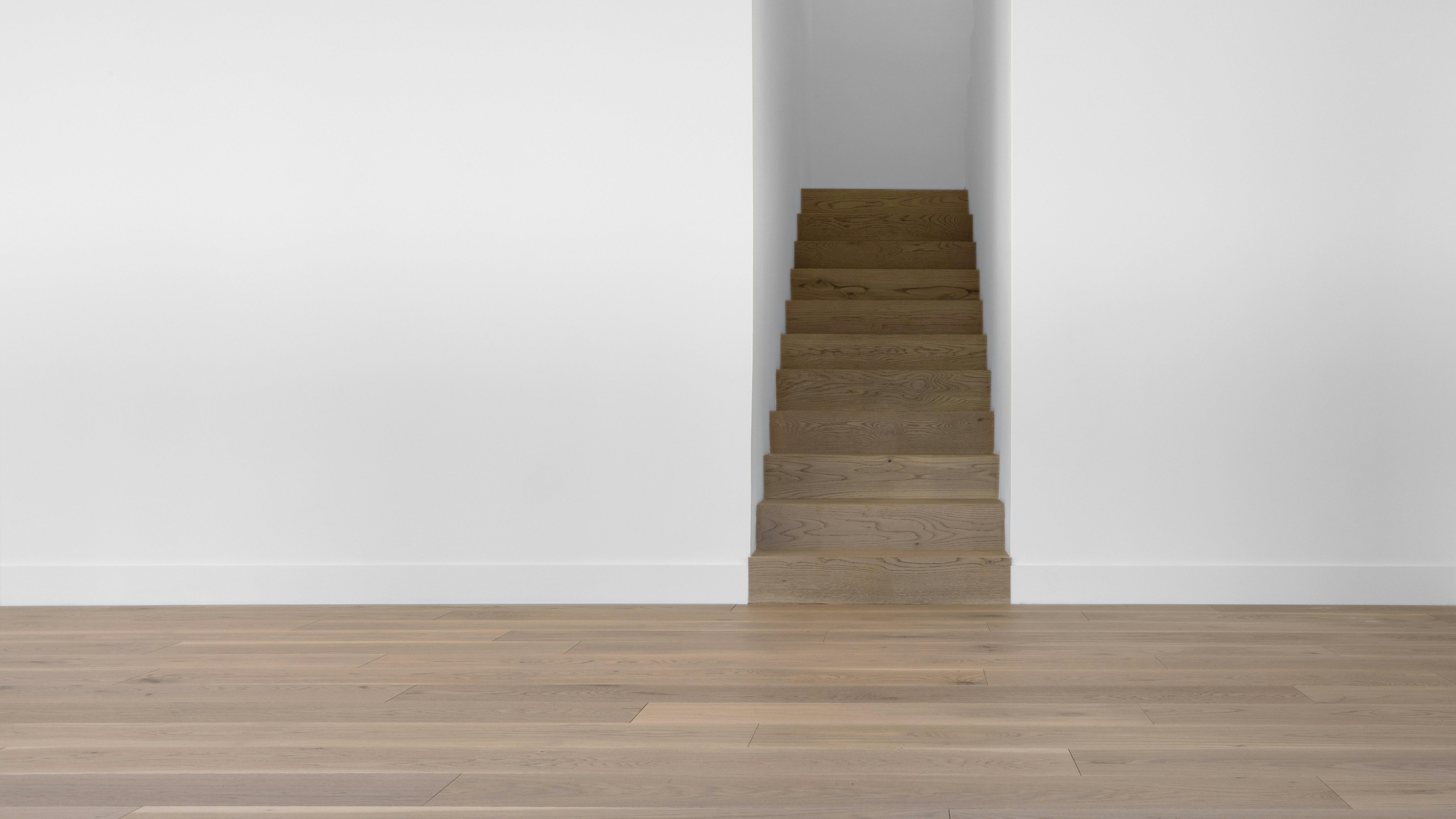 Oak Bois Flott&eacute; brings one refined French oak color across four formats. The flooring is shown installed on stairs.