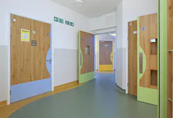 Intersection of hospital unit spaces with color-coded doors for restrooms (blue), patient rooms (green), and staff spaces (yellow)