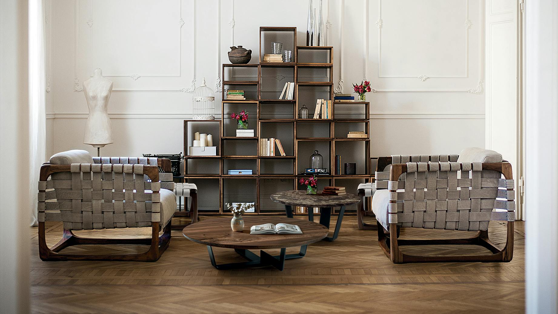 Two Bungalow Armchairs set up in a living area with tables and shelving.