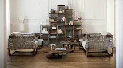 Two Bungalow Armchairs set up in a living area with tables and shelving.