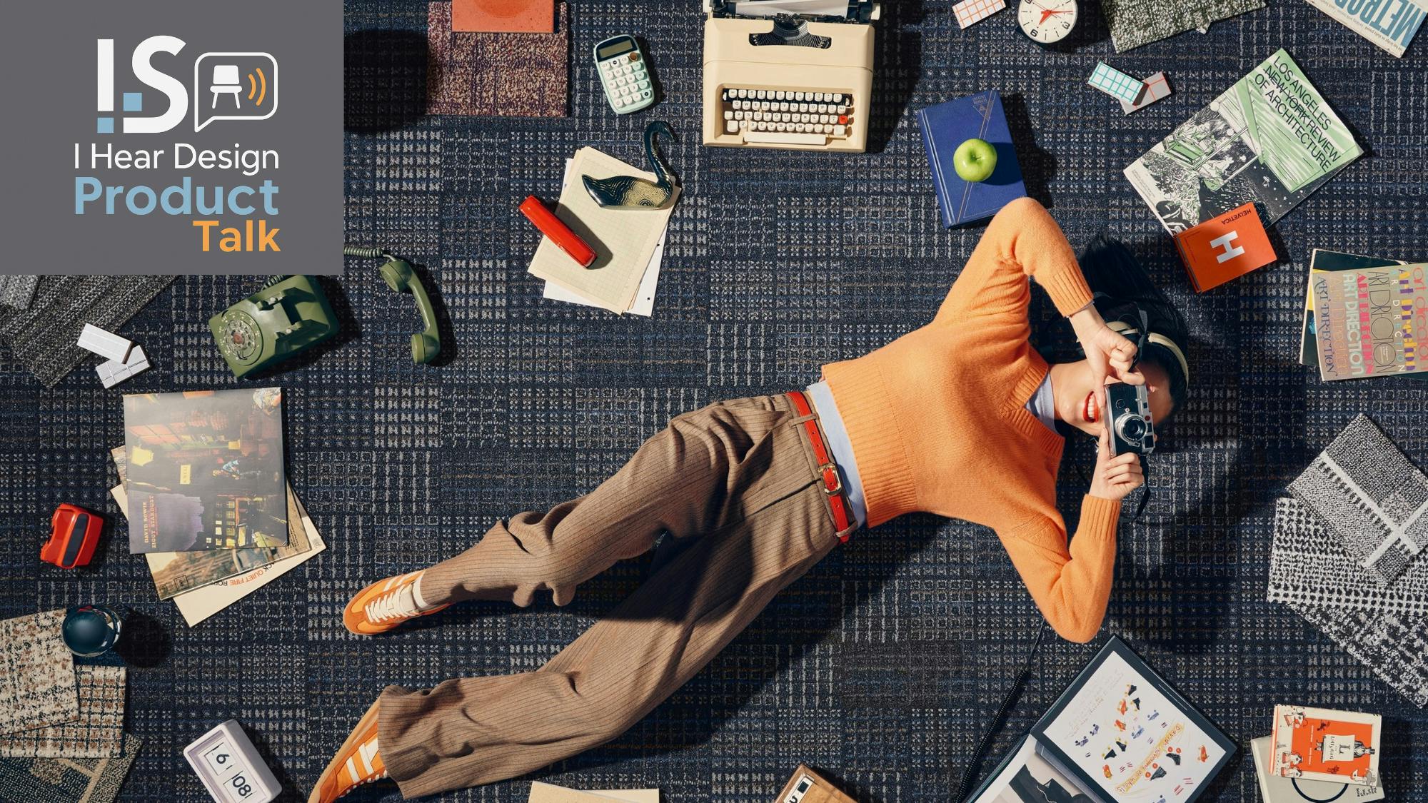 A woman lays on the floor, holding a View-Master, while surrounded by the Cult Classics collection from Shaw Contract.