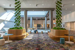 An open, informal seating area featuring custom benches with plant installations