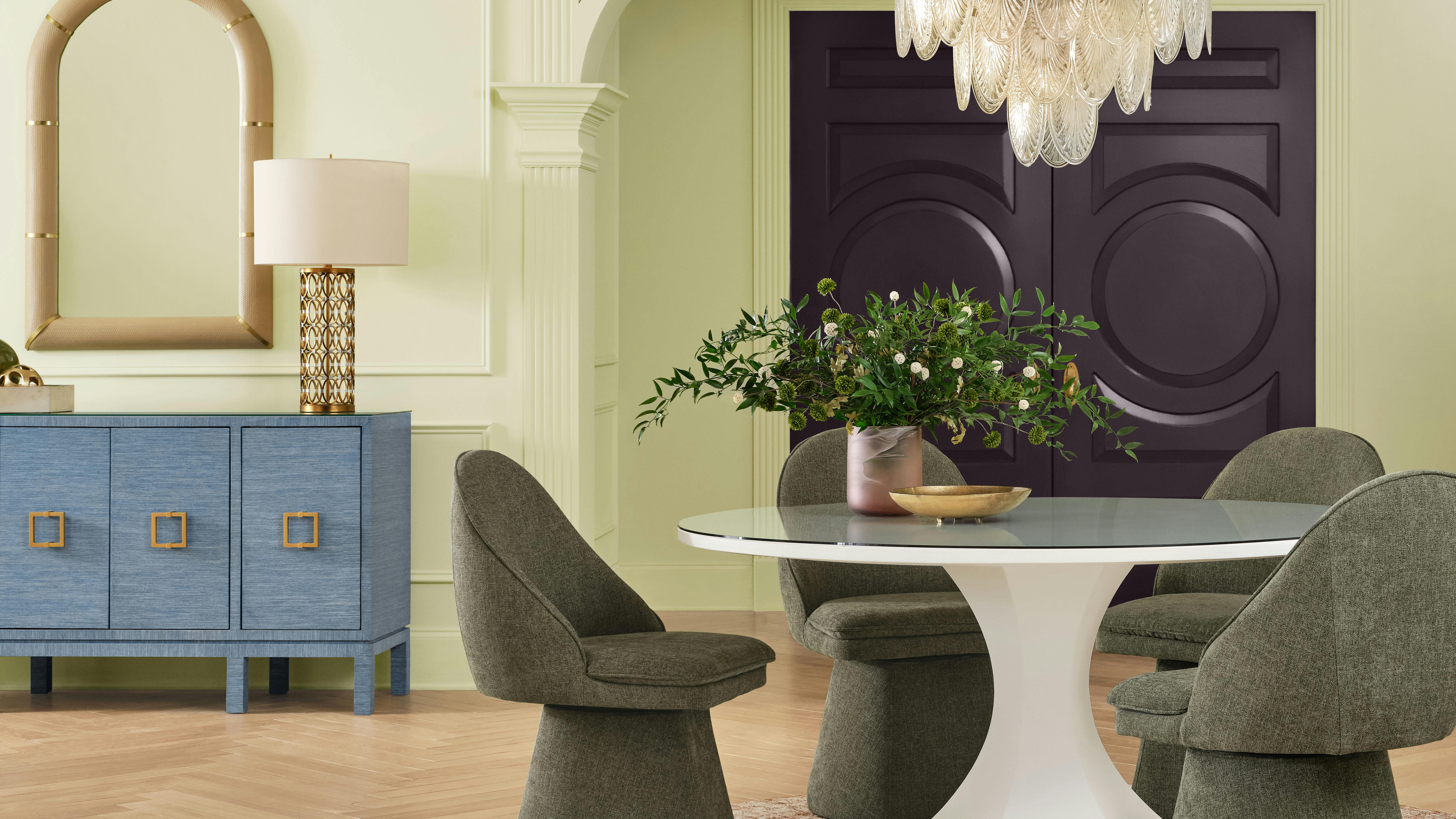 Celery-colored walls are painted in a dining room.